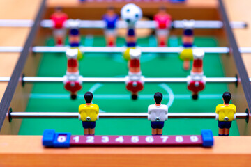 Close up table soccer with players and a ball.