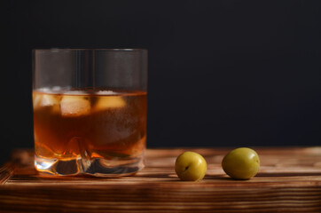 whiskey and coke, with olives on a black background