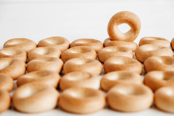 Drying or mini round bagels on a white wooden background. Top view. Copy, empty space for text
