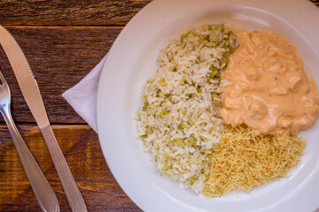 Delicious healthy food with chicken strogonoff with rice and french fries on dish. View from the top