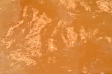 Isolated macro of surface of orange calcite rock