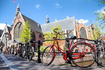 Fototapeten bicycle, symbol of Amsterdam, Netherlands in front of the Oude Kerk (Old Church) from across the Oudezijds Voorburgwal canal © eclypse78