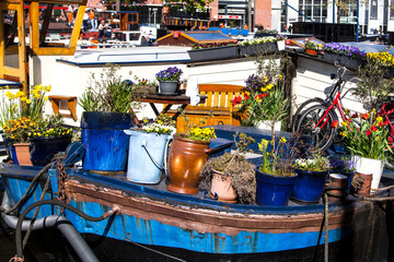 Fototapeta na wymiar house boat decorated with flowers canal scene amsterdam holland