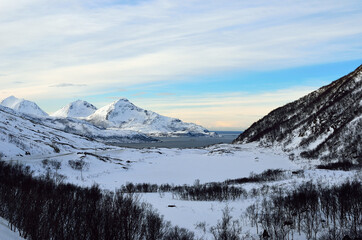 snowy mountain with sunshine blue sky and fjord landscape