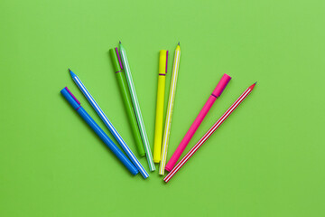 multi-colored pens and pencils, school stationery, copy space