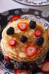 Delicious pancakes with blackberries and strawberries