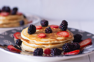 Delicious pancakes with blackberries and strawberries
