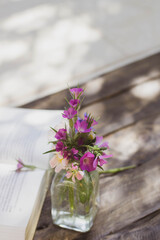 open book and vase on wooden table