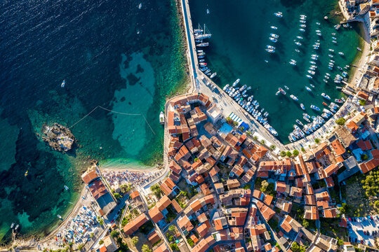 Aerial view of a jetty surrounded by houses on sunny day in Komiza, Croatia