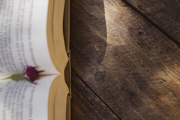 open book and vase on wooden table