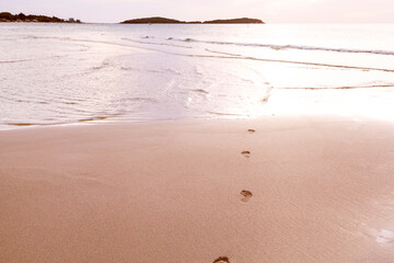 Chaweng, Koh Samui Island in Thailand. Footsteps on the golden sand going to the ocean