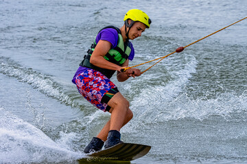 Teenager wakeboarding on a lake - Brwinow, Masovia, Poland