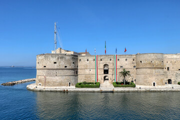 View of the Aragonese Castle with Italian flags to celebrate April 25, Italy's Liberation Day - Taranto, Puglia, Italy