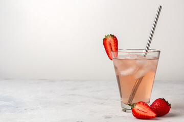 Strawberry lemonade with ice on a light background