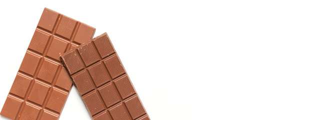 Bar of milk chocolate with nuts inside on white background flat lay top view copy space. Minimalistic Chocolate Background. Chocolate, cocoa, sweet treat, sugar, overweight, chocolate addiction