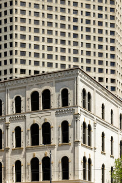 Classic and new buildings juxtapose arches, diagonals, and squares in two buildings along the skyline of Milwaukee, Wisconsin