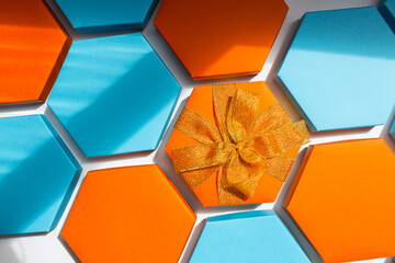 A close up beautiful blue and orange hexagon gift boxes on the white background. One of them with...