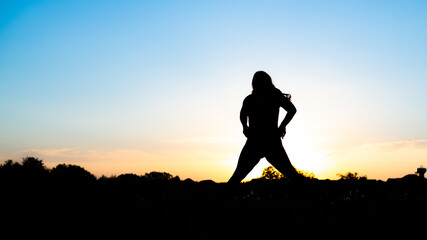 Silhouette of woman standing in the sunset