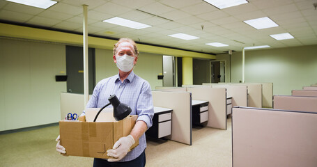 Man leaving job business office closed due to Covid-19 Coronavirus