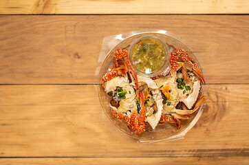 .Fresh steamed crab select crab claw on a plate with seafood sauce ready to serve in white background.