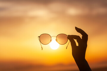 Showing the sunset through sunglasses