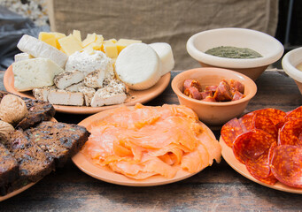 Display of Mediterranean food during medieval festival in Malta: salami, cheese, pesto, bread, salmon, sausage