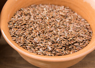 Brown flax seeds in clay pot