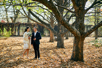 Fototapeta premium Young male and woman just married. Concept of happy family. Modern family outdoor.