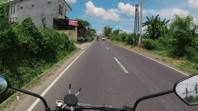 Riding a motorcycle in the first person on bali