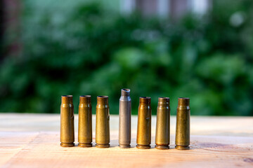 cartridges from a cartridge gun on a wooden background
