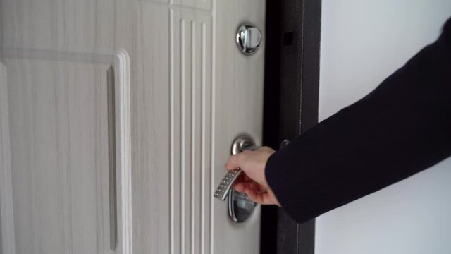 Man in a blue suit walks home through the door. Office worker coming and exit through the door