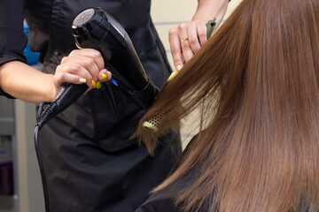 Fototapeta premium hair dryer drying. hair styling in a beauty salon. hair care.