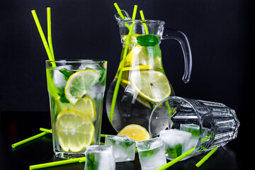 Mojito cocktail in glasses on black table. 