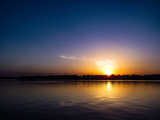 Naklejka premium sunset over the river