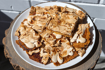 Close-up and top view of oblong pieces of home-made crumble cake with strawberry jam covered with...