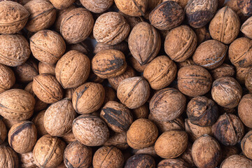 Scattered whole walnuts texture. Pattern, nuts background, texture close-up
