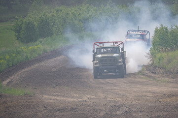 autocross on trucks and cars in summer, dirt, heat, dust