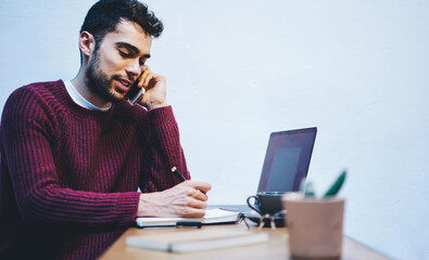  Bearded cheerful man using modern technology with high speed internet