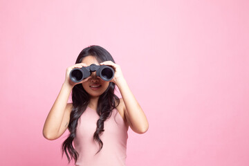 Young Asian woman with binoculars.