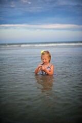 Young girl playing in the ocean