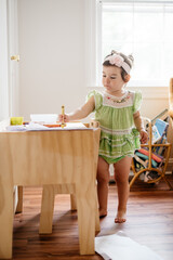 Toddler girl drawing with crayons