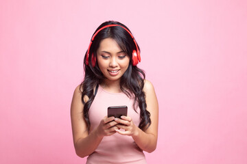 Pretty asian girl listening music with her headphones.