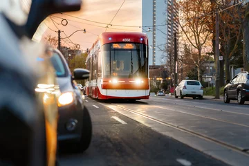 Foto op Canvas A streetcar approaches on a Toronto street at sunset © scottshoots