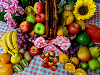 Delicious and healthy fruits, rich in vitamins and minerals, displayed in a beautiful picnic basket.