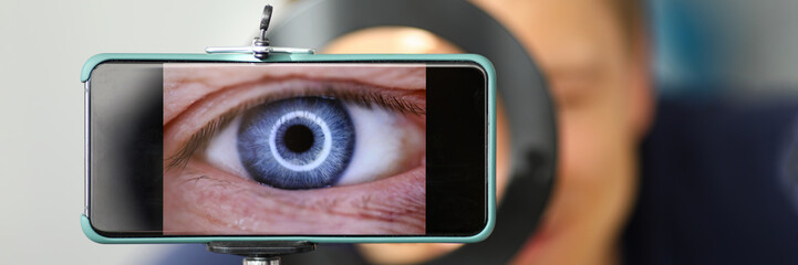 Man making video trying to shoot his own eye using modern smartphone camera