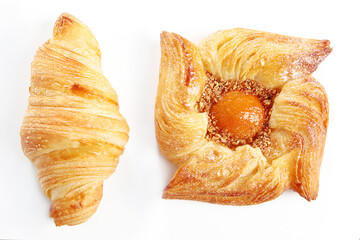 Danish puff with apricot jam and croissant on a white background. An isolated object. Copy of the space. Top view.