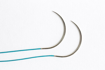 surgical needles on white background