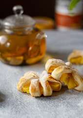 Puffs with pineapple on a gray table.