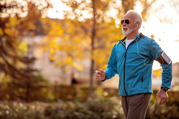 Senior man jogging outdoors.
