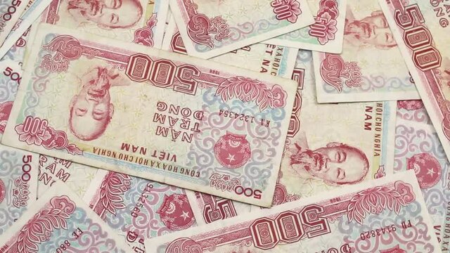 A close up video of colorful five hundred dong bank notes rotating in a circle